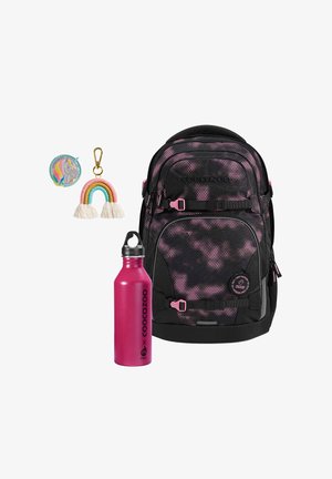 Backpack with black and pink spotted design, featuring multiple pockets; includes a pink water bottle and colorful keychain with a rainbow accent.