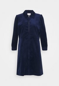 Navy corduroy-mekko, jossa on kaulus, pitkät puffihihat, edessä vetoketju ja elastiset hihansuut lisärakenteen vuoksi.