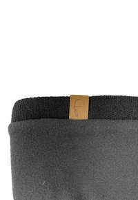 Black fleece boot with a textured black knitted top, featuring a light brown leather tag with an embossed logo on the outside edge.