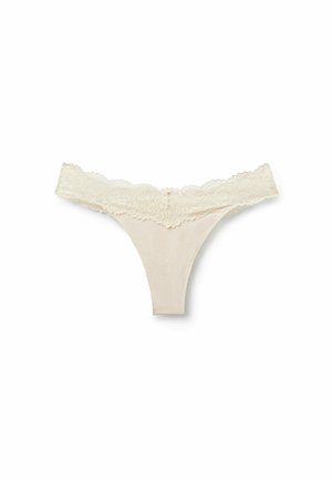 Beige cotton thong with a wide lace waistband featuring floral patterns, laid flat on a white background.