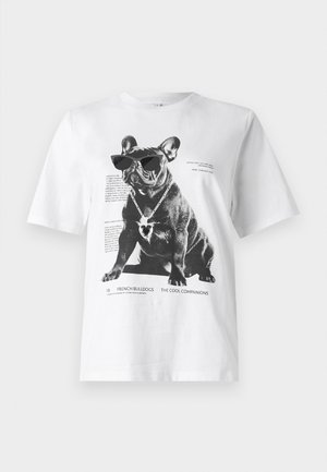 White graphic t-shirt featuring a black French bulldog wearing sunglasses and a heart-shaped necklace, with printed text and design details.
