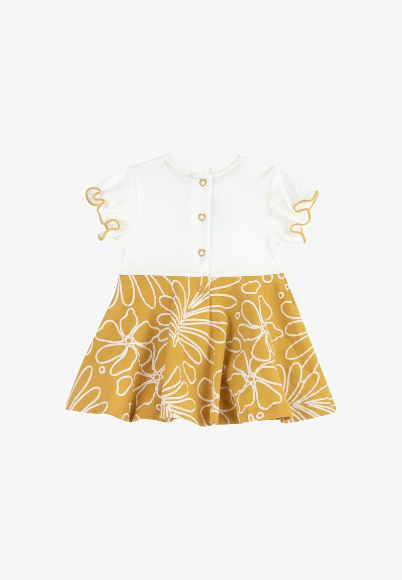 Robe blanche pour bébé avec manches courtes à volants et jupe à motifs floraux jaunes, ornée de boutons en forme de cœur dans le dos.