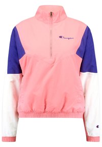 Chaqueta ligera de media cremallera en rosa con paneles en azul y blanco; cuenta con puños y cintura elásticos; logo bordado en el pecho.