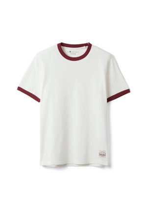 Weißes kurzärmeliges T-Shirt mit dunkelrotem Besatz am Kragen und an den Ärmelkanten sowie einem kleinen rechteckigen Etikett nahe dem unteren Saum.