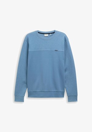 Modrá mikina vyrobená z měkké tkaniny, s texturovanou horní částí, dlouhými rukávy a kulatým výstřihem. Malé logo poblíž lemu.
