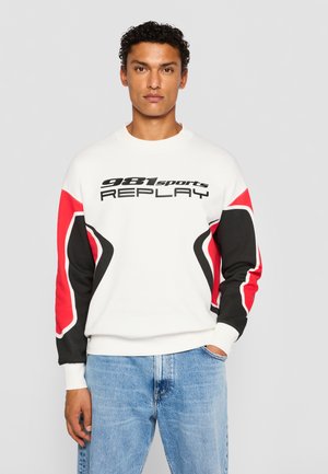 White sweatshirt with black and red accents, featuring a bold graphic print and a crew neck. Soft cotton material with ribbed cuffs.