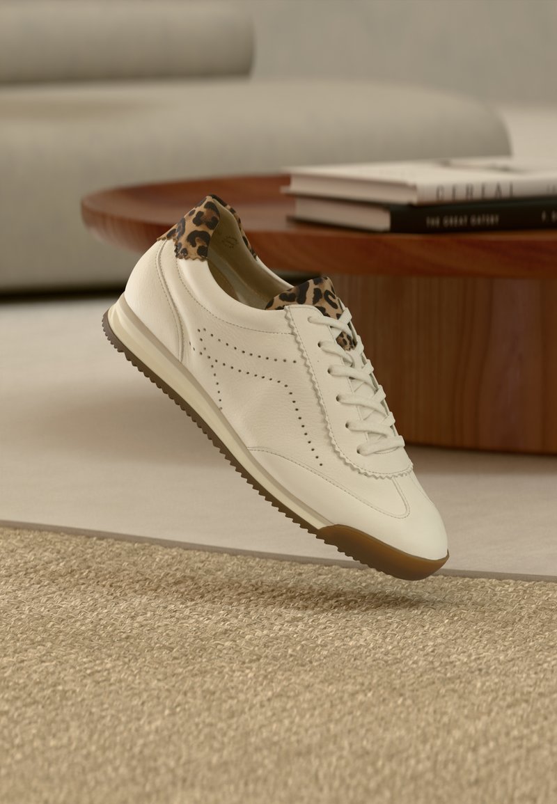 Baskets en cuir blanc avec un col imprimé léopard, des côtés perforés et une semelle en gomme, conçues pour un usage décontracté.