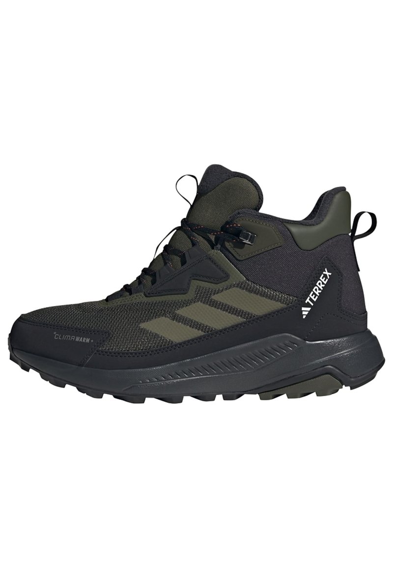Schwarz-olivgrüne mittelhohe Wanderschuhe mit einem strukturierten Mesh-Obermaterial, Gummisohle, ausgeprägtem Profil und Riemen für einen sicheren Sitz.