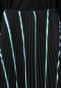 Black pleated skirt featuring alternating vertical stripes in light blue. Texture is smooth with crisp pleats for structured appearance.