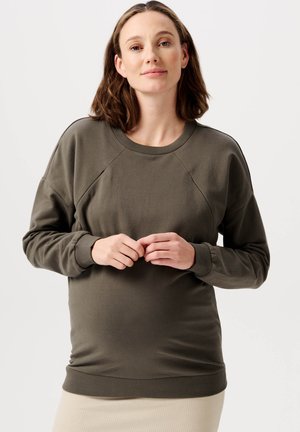 Dunkelgrüner Sweatshirt mit Rundhalsausschnitt, Raglanärmeln und gerippten Bündchen. Hergestellt aus weichem Stoff, weist es ein tailliertes Design auf.