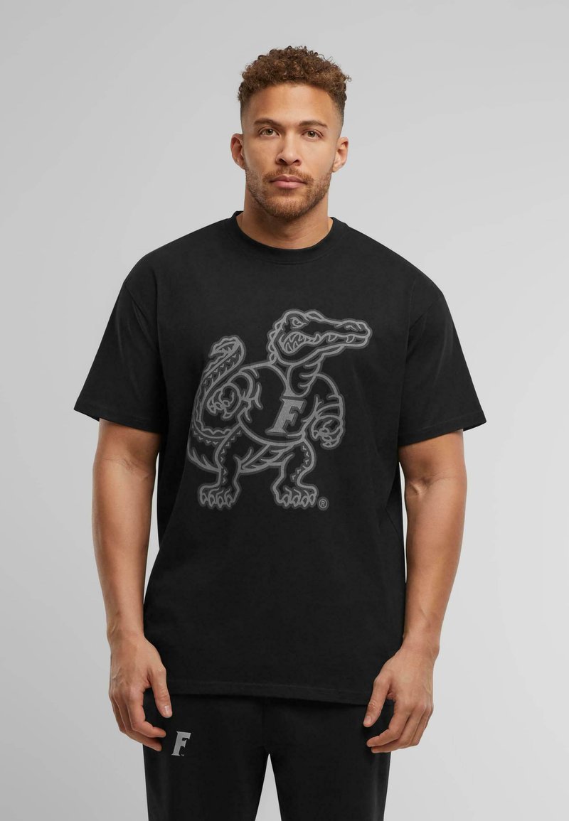 Black cotton t-shirt featuring a large, gray graphic of an alligator with the letter "F" on its torso. Crew neck and short sleeves.
