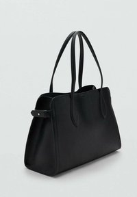 Black leather tote handbag with two long shoulder straps and a side buckle detail on a plain light background.