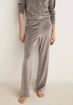 Tuta in velluto grigio con felpa con zip e pantaloni a zampa d'elefante, caratterizzato da una texture morbida e due tasche frontali.