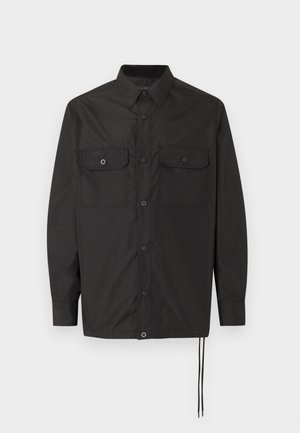 Sort langærmet skjorte med knapper, to forlommer med klap og justerbare snore i kanten, vist mod en ensfarvet baggrund.