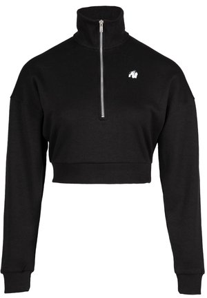 Zwarte cropped sweatshirt met een hoge kraag, kwart-ritssluiting, geribde onderrand en lange mouwen. Bevat een klein wit logo op de borst.