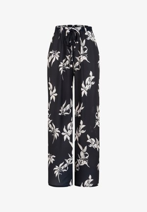 Zwarte broek met wijde pijpen, witte bloemenprint en een elastische tailleband met een zwart trekkoordje aan de voorkant.