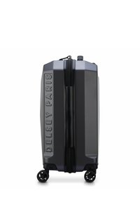 Hardshell suitcase in dark gray with textured finish, embossed brand logo, top handle, side wheels, and a black zipper.