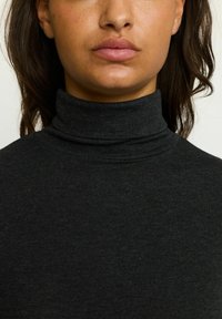 Dark gray turtleneck sweater featuring a close-fitting design, soft texture, and subtle stitching along the neckline.
