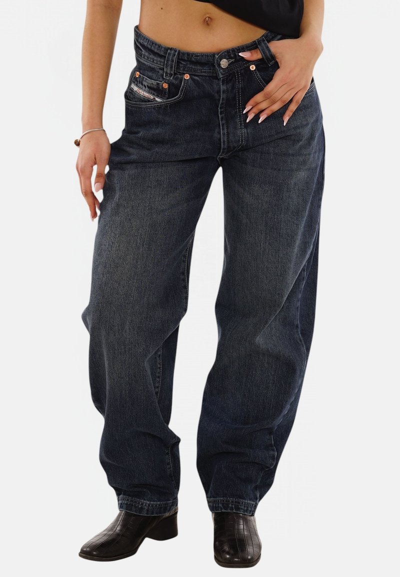 Dark blue denim jeans with a relaxed fit, featuring orange stitching, front pockets, and a button closure. Smooth texture, straight leg design.