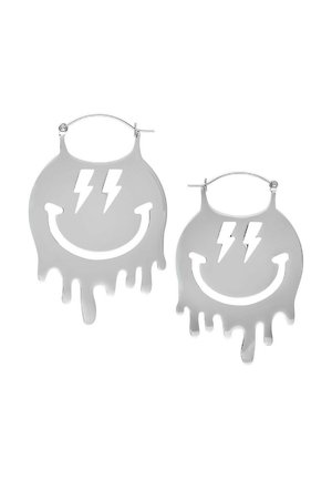 Silver hoop earrings shaped like dripping smiley faces, featuring lightning bolt cutouts. Smooth metallic finish, bold graphic design.