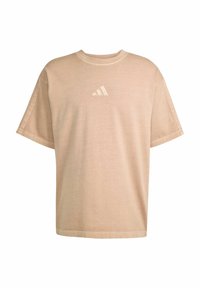 Beige, short-sleeve t-shirt made of soft cotton; features a small white trefoil logo on the chest and a relaxed fit.