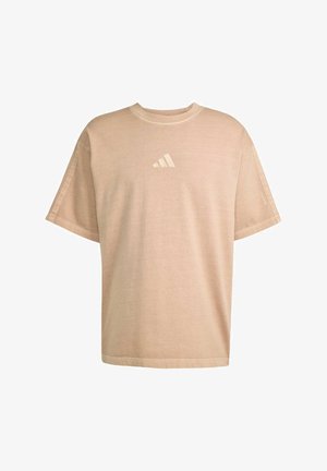 Beige, short-sleeve t-shirt made of soft cotton; features a small white trefoil logo on the chest and a relaxed fit.