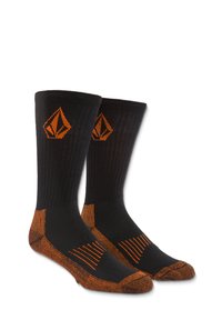 Des chaussettes noires avec des accents orange, incluant un logo et des détails rayés. Fabriquées à partir d'un matériau extensible avec un design côtelé pour plus de confort.