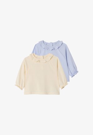 Two long-sleeve toddler tops with ruffled collars and elastic cuffs, one in cream and one in light blue, on a white background.