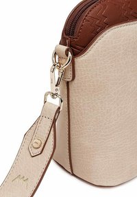 Beige strukturierte Lederumhängetasche mit braunen Akzenten, goldenen Beschlägen und einem abnehmbaren Riemen. Mit einem Reißverschluss oben.