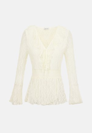 Elevandiluust pitsist pikkade varrukatega pluus V-kaelusega, volangidega kraega, paelaga ees, soonikkoes vöökohaga ja lehvitega mansettidega.