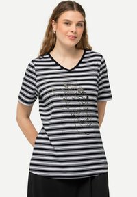 Czarny i biały t-shirt w paski, z dekoltem w serek, krótkimi rękawami i graficznym wzorem z przodu. Miękka tkanina o luźnym kroju.