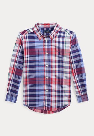 Chemise à manches longues à carreaux avec des carrés rouges, bleus, blancs et verts, comportant un col boutonné et le logo Polo Ralph Lauren sur la poitrine.