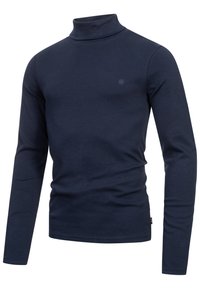 Chemise à col roulé bleu marine à manches longues, coupe ajustée avec un petit logo ton sur ton sur le côté gauche de la poitrine.