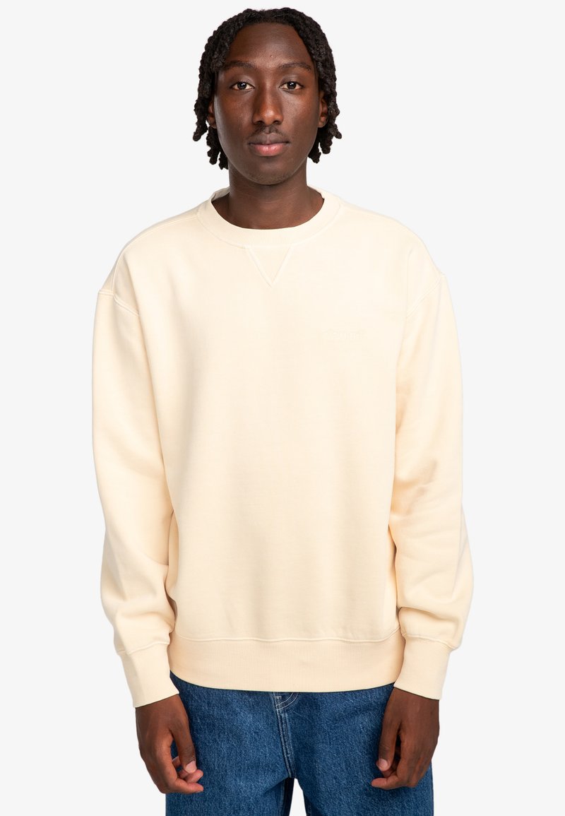 Lichtbeige sweatshirt met een ronde halslijn, ribbelcuffs en -zoom. Gemaakt van zachte stof, met een subtiele merkl logo op de borst.
