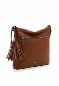 Brown leather crossbody bag with a textured surface, featuring a zipper closure, a tassel accent, and a metal logo plate on the front.