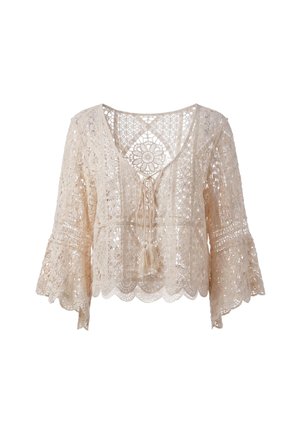 Beige blondetop med blomster- og geometriske mønstre, klokkeærmer, V-hals og frynsebindedetalje foran.