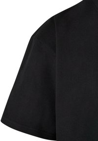 Black cotton t-shirt featuring a relaxed fit, short sleeves, and a smooth texture. The neckline is crew-sized with minimal stitching details.