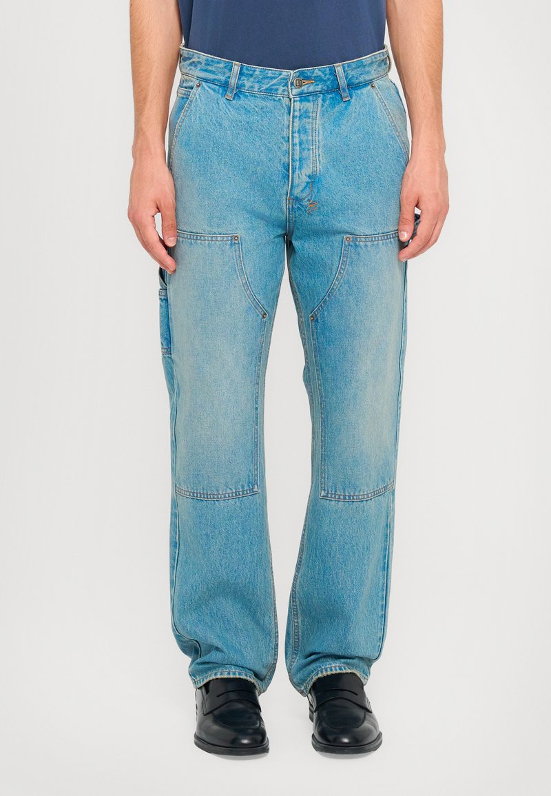 Lyseblå denimjeans med en afslappet pasform, der har store sidelommer, syede detaljer og en knaplukning i taljen.