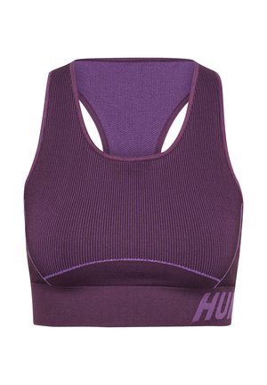 Lilla sportsbh med ribbet tekstur, racerback-design og kontrasterende syninger. Har en bred kant med ordet "HUM" trykt i hvid.