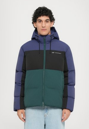 Padded jacket featuring a color-block design in navy blue, black, and green. It has a zip closure, adjustable hood, and smooth texture.