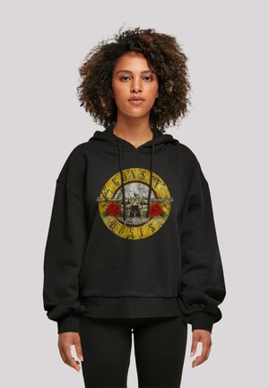 Black hoodie with a graphic design featuring a circular yellow motif, red roses, and a central illustrated scene. Soft fabric, relaxed fit.