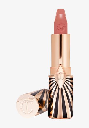 Lipstick in a gold and black striped tube with a pointed tip. The cap features a diamond-shaped emblem and engraved lipstick imprint.