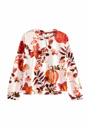 Langærmet bluse i blødt stof med et blomster- og græskar-mønster i varme nuancer af orange, rød og brun på en lys pink baggrund.