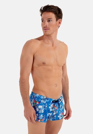 Shorts de bain fleuris bleus avec taille élastique, présentant un motif vibrant de fleurs et de formes abstraites, fabriqués en matériau léger.