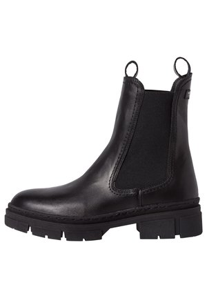 Bottine noire en cuir avec panneaux latéraux élastiques, languettes à l'avant et à l'arrière, et semelle épaisse crantée.