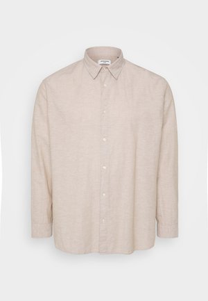 Kerge beeži värvi pika varrukaga särk, mis on valmistatud linasesest kangast, varustatud nööpidega kaelusega, esistel nööpidega ja lõdva lõikega, mille varrukad on kinnitatud.