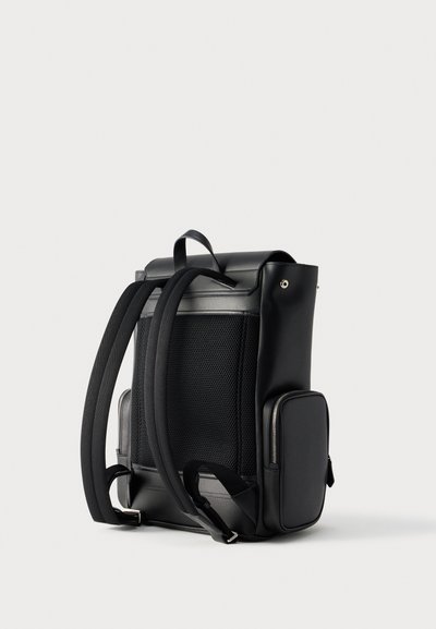 Black backpack with padded shoulder straps, mesh back panel, small zippered side pocket, and top handle on a white background.