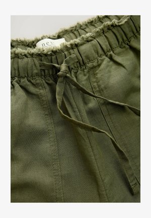 Olive green shorts with an elastic waistband, adjustable drawstring, and textured frill detail along the top. Made from lightweight fabric.