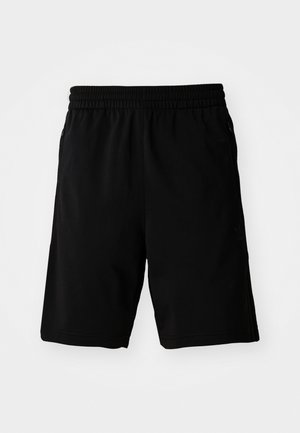 Schwarze Sportshorts aus synthetischem Material mit einem elastischen Bund und seitlichen Taschen. Glatte Textur ohne erkennbare Muster.