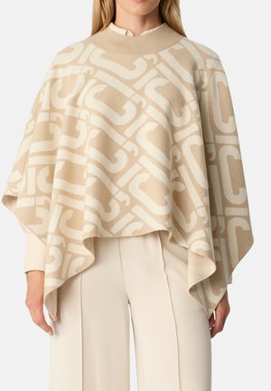 Poncho beige con motivo astratto crema, realizzato in tessuto morbido. Presenta un collo alto e un design drappeggiato, che arriva sotto la vita.
